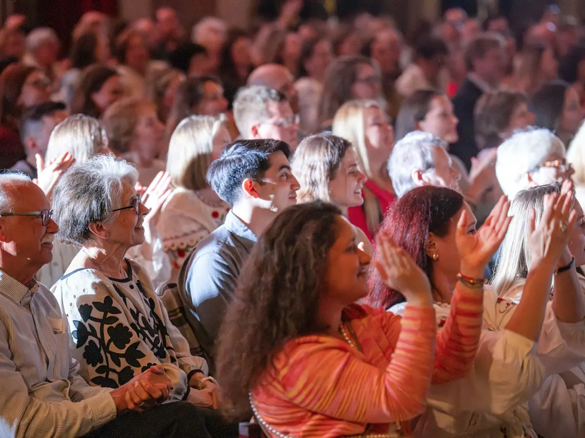 Audience applauding live entertainment at a corporate event