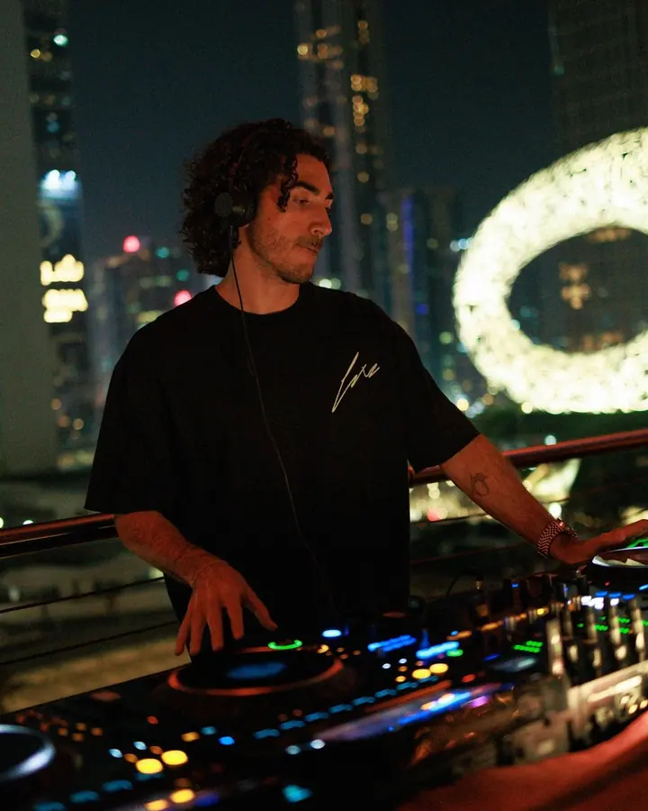 DJ performing at a corporate party in Dubai with the Museum of the Future in the background