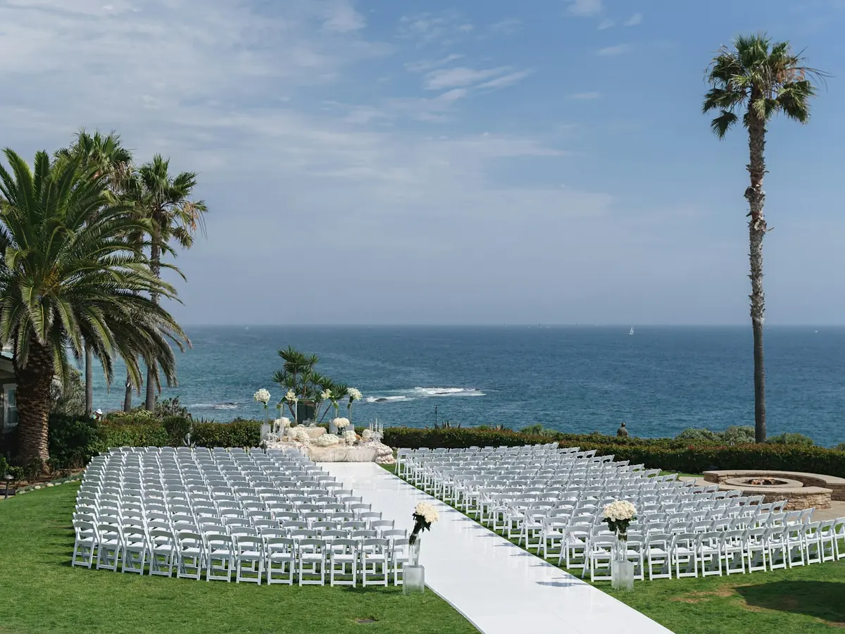 Outdoor wedding ceremony by the sea with palm trees