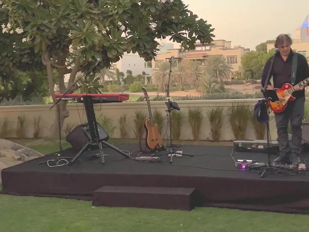 Guitarist on stage at sunset at a villa party in Dubai